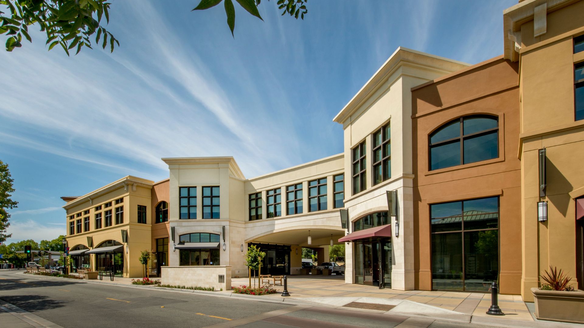 Modern office building complex with yellow and white exterior on sunny day