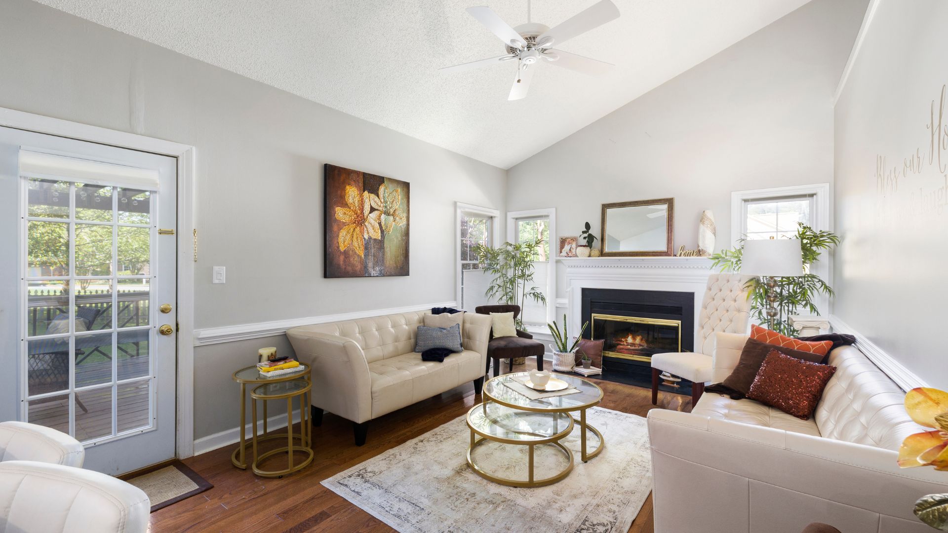 Cozy living room with white sofas, fireplace, and golden coffee tables