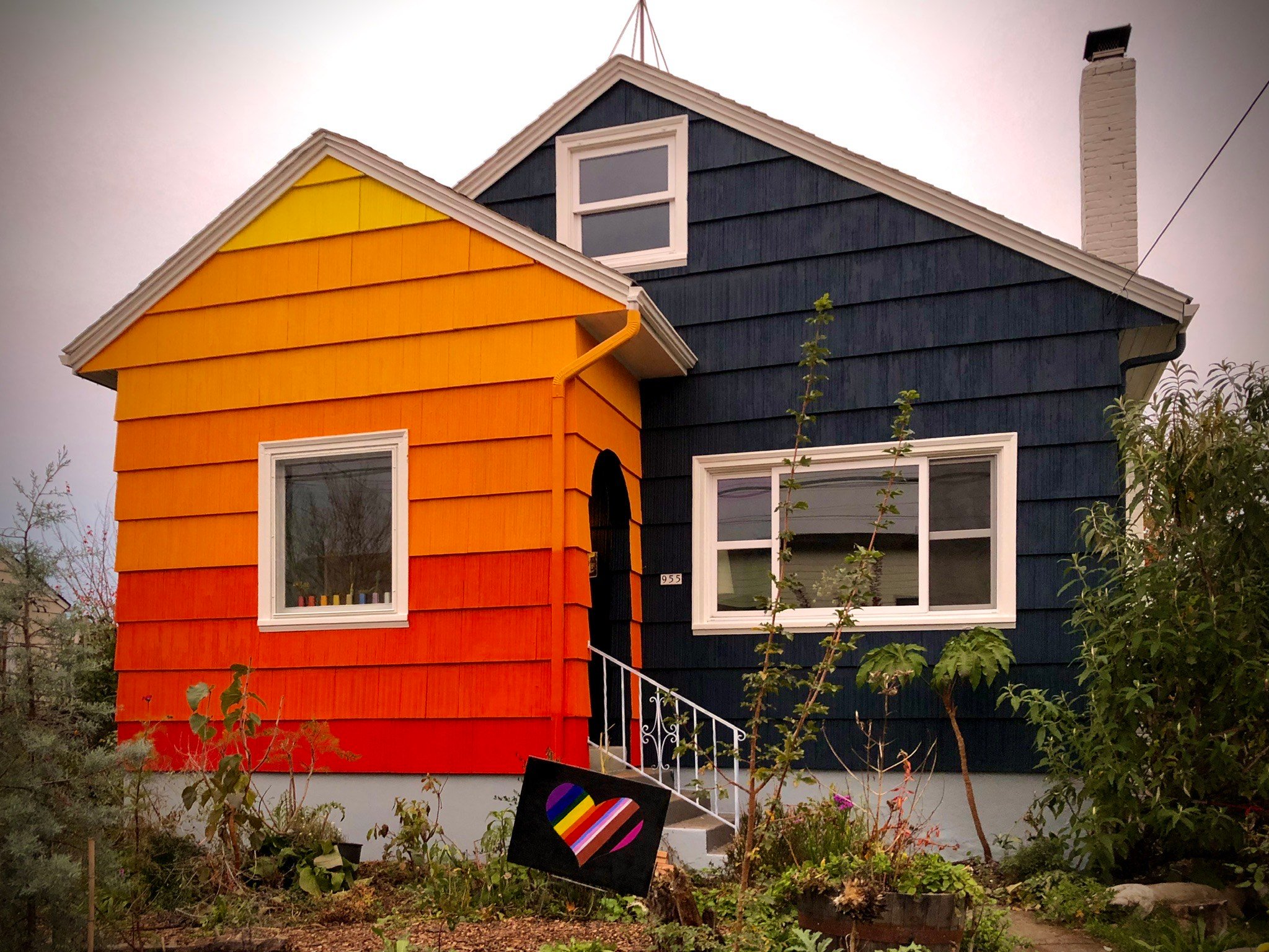 Two-toned colorful house with yellow-orange and navy blue siding